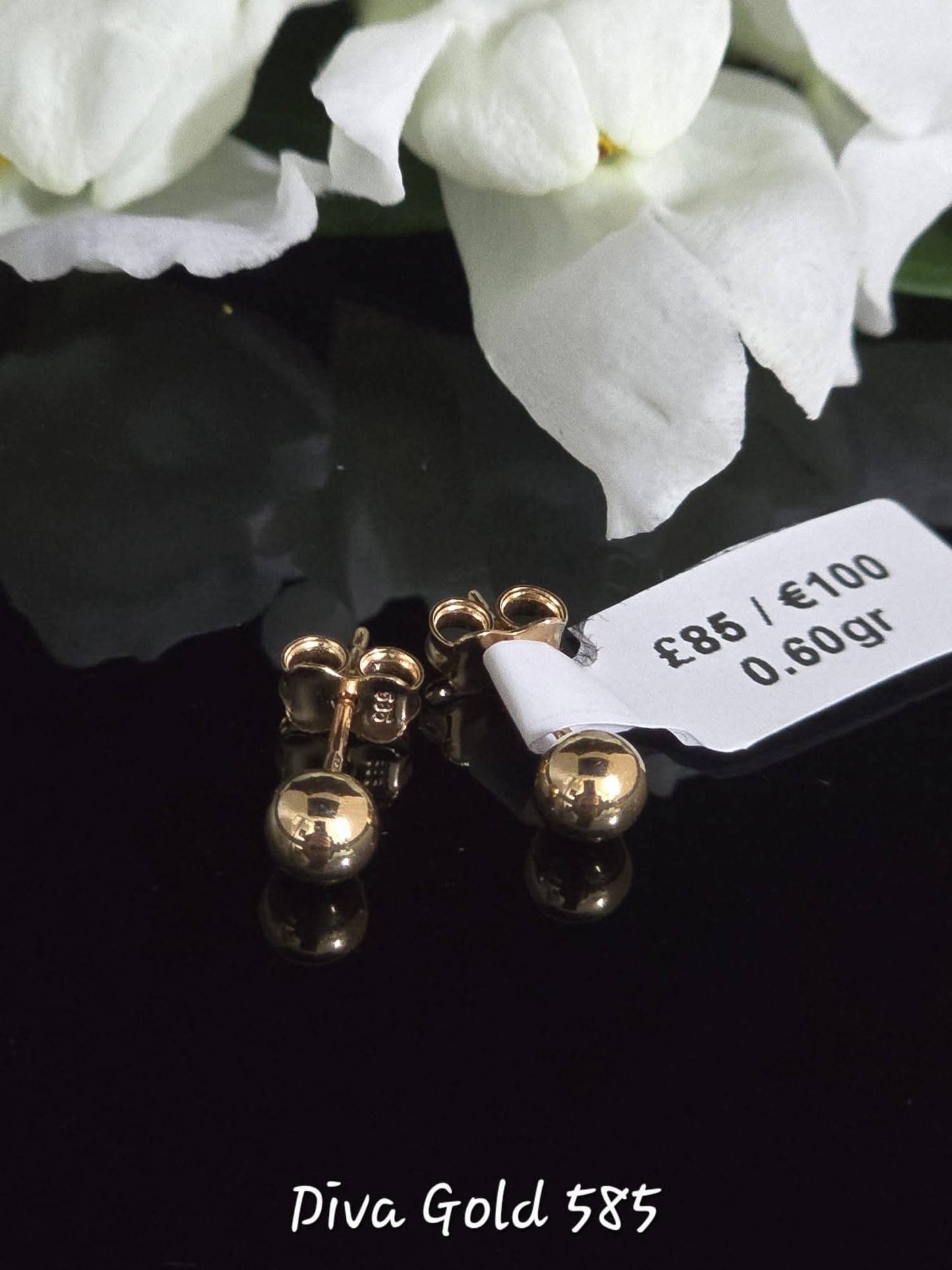 Stud gold earrings.
