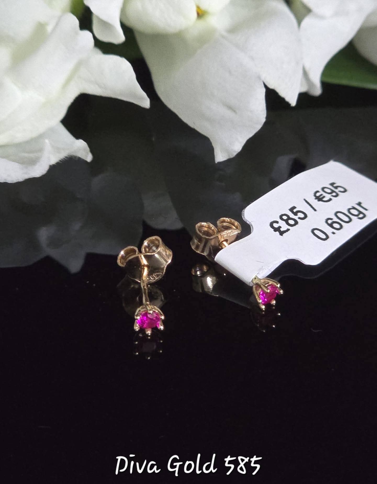 Stud gold earrings with pink zircon stones.