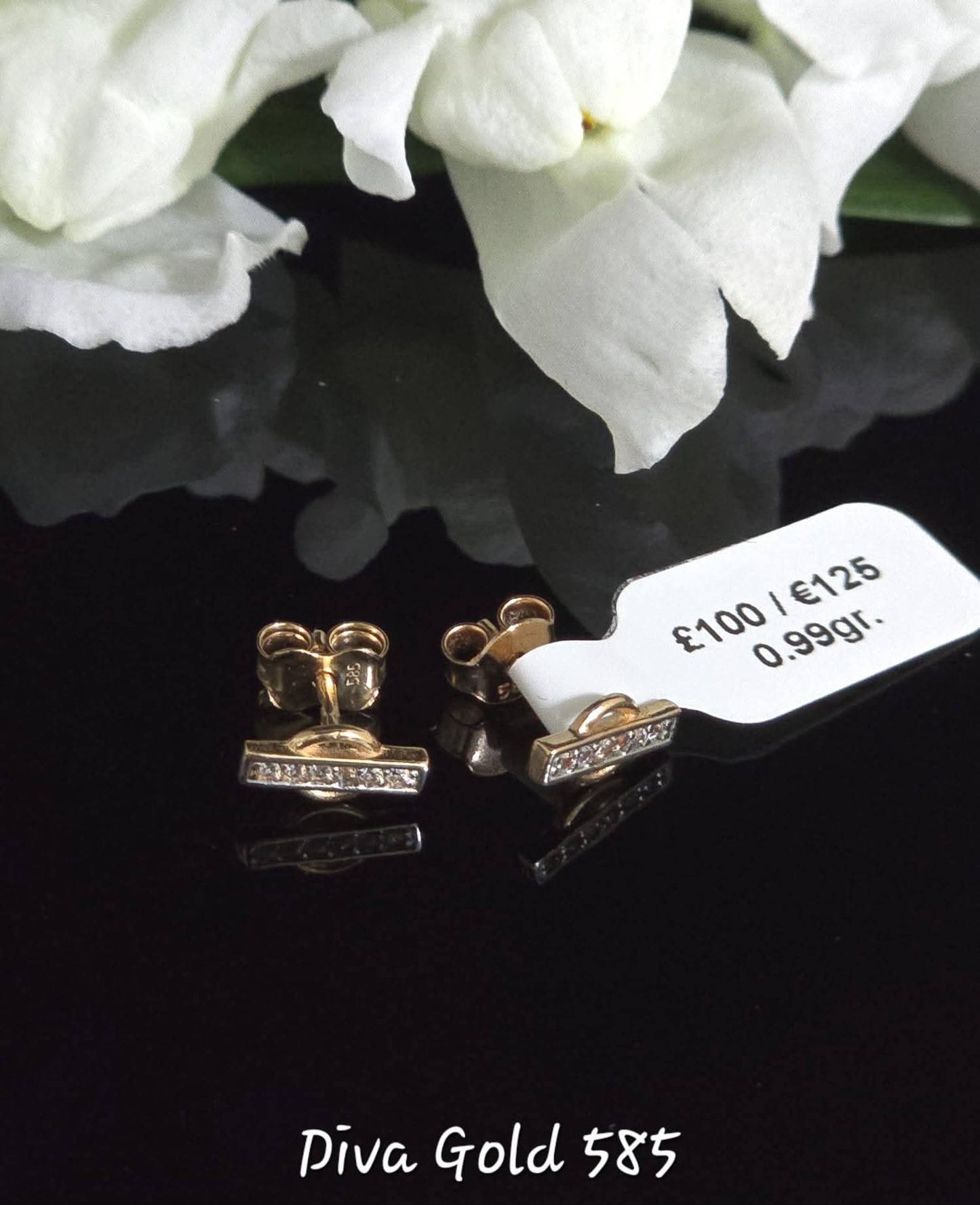 Stud gold earrings with white zircon stones