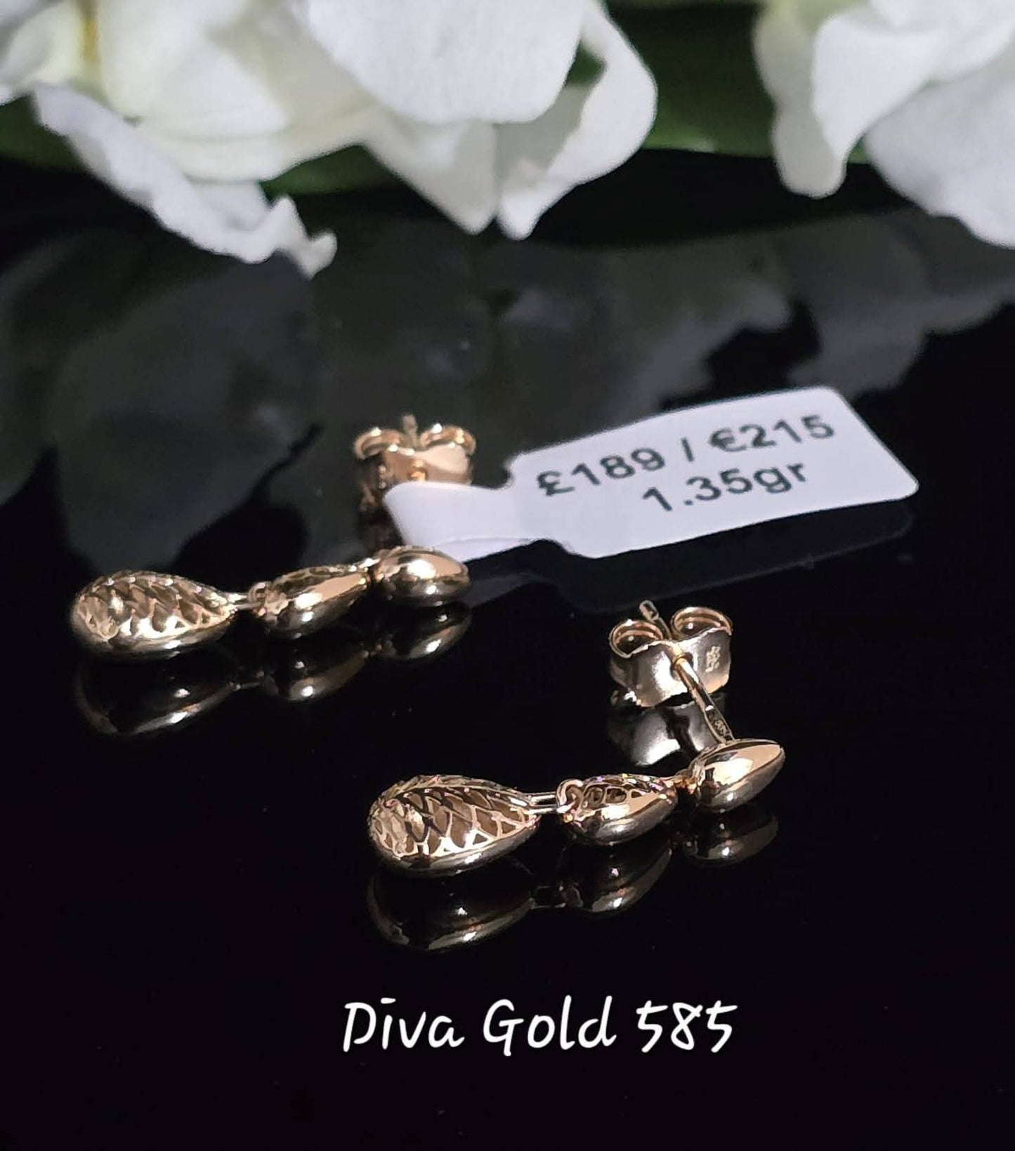 Stud gold earrings.