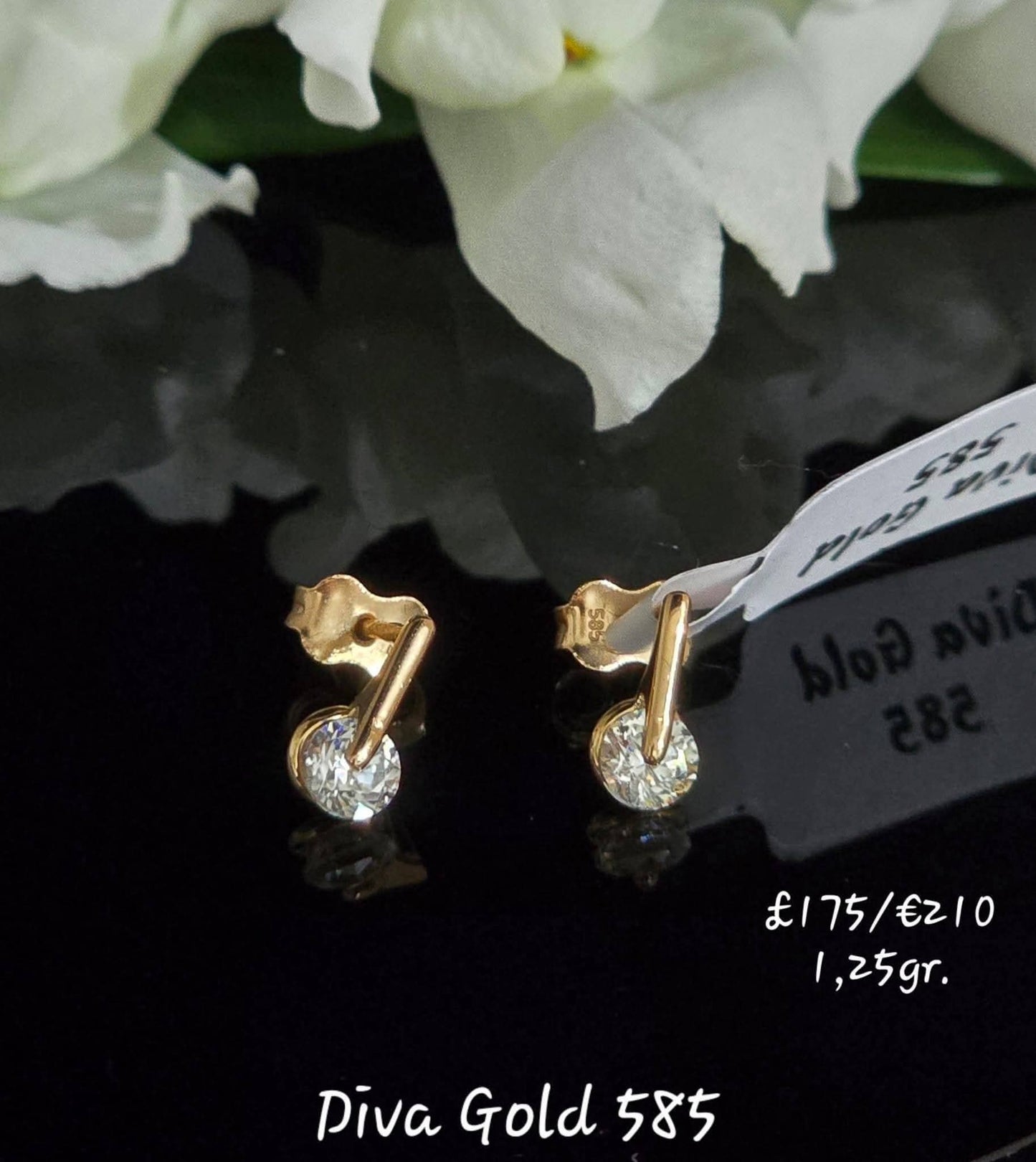 Stud gold earrings / white zircon stones.