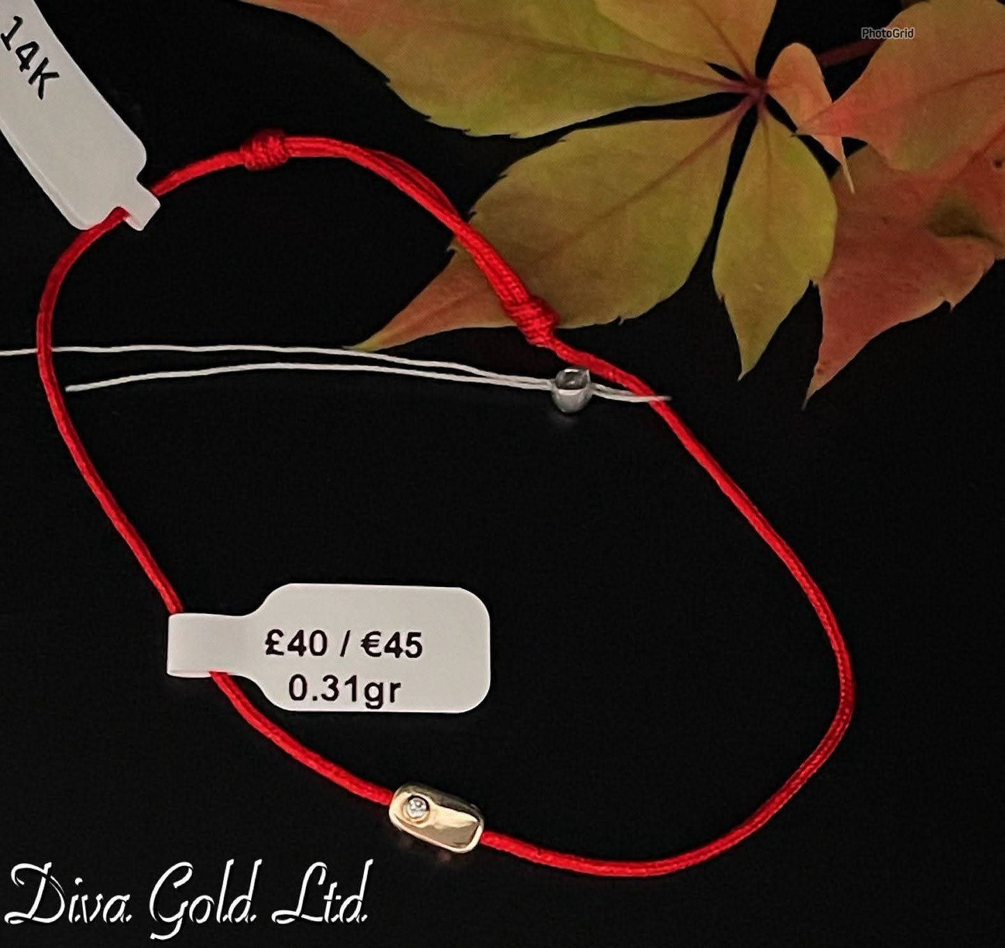 Red thread bracelet with gold details.