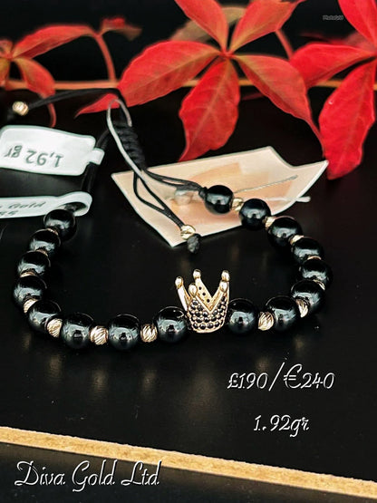 Black thread bracelet with gold details.