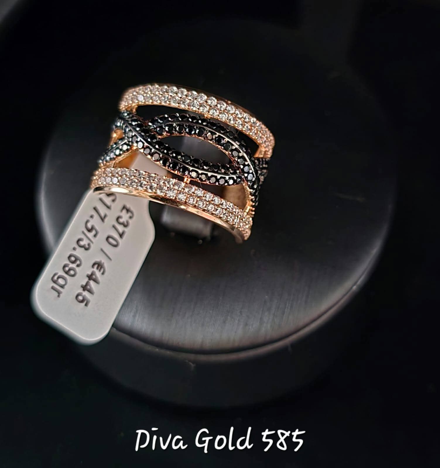 Gold ring with white&black zircon stones.  Size 17.5