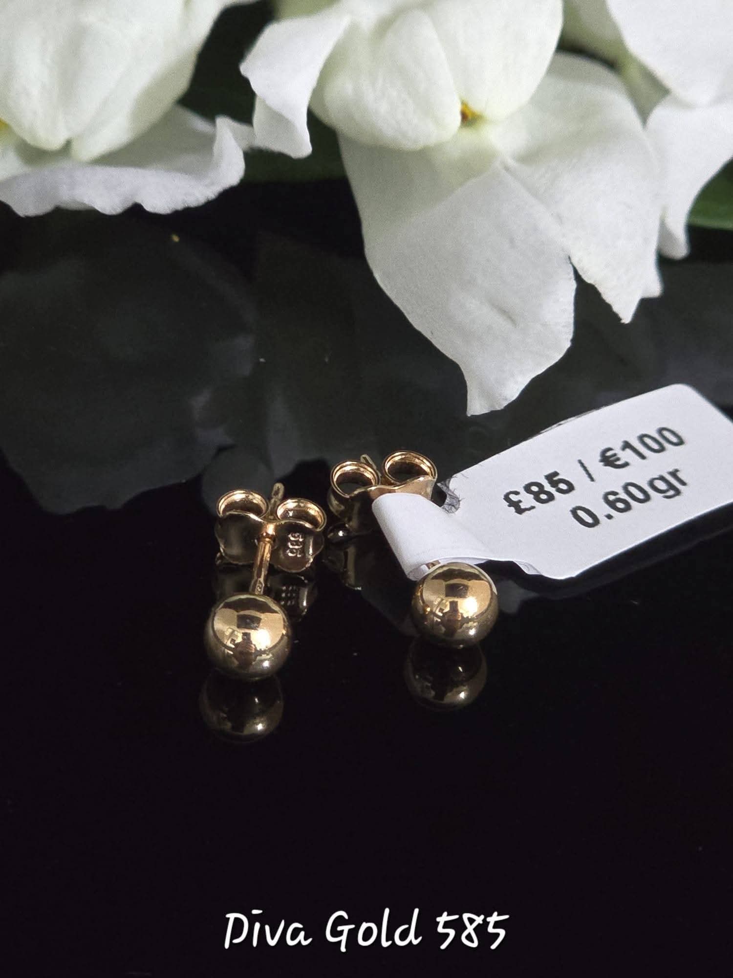 Stud gold earrings.