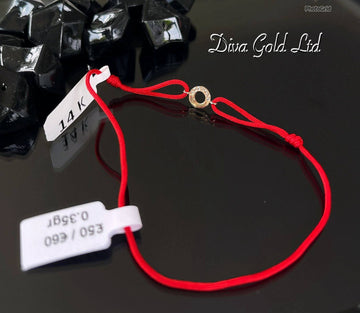 Red thread bracelet with 585 gold details. 0.35gram