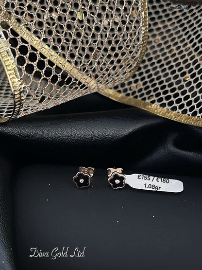 Stud gold earrings.