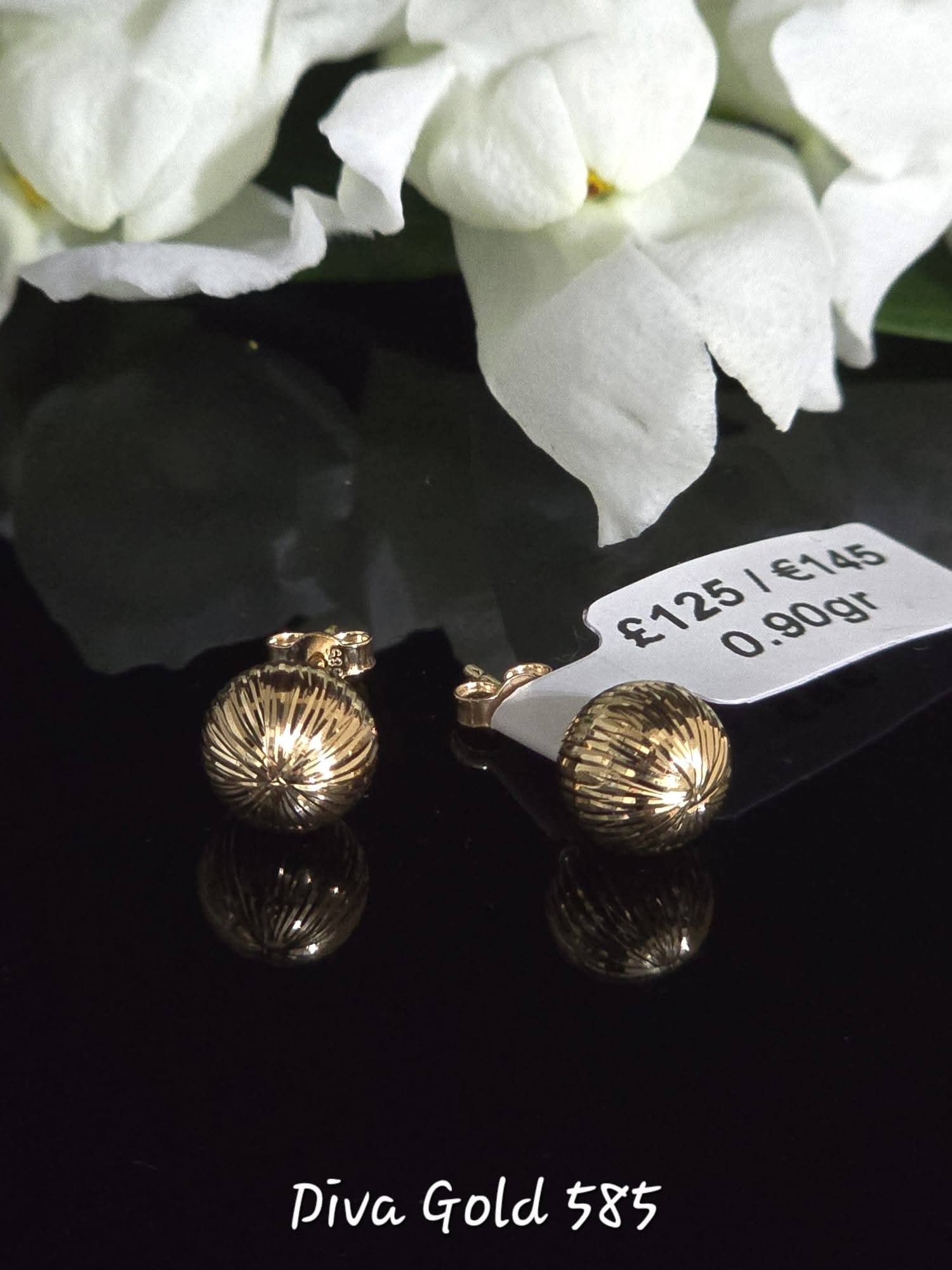 Stud gold earrings.