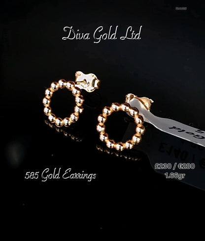 Stud gold earrings.