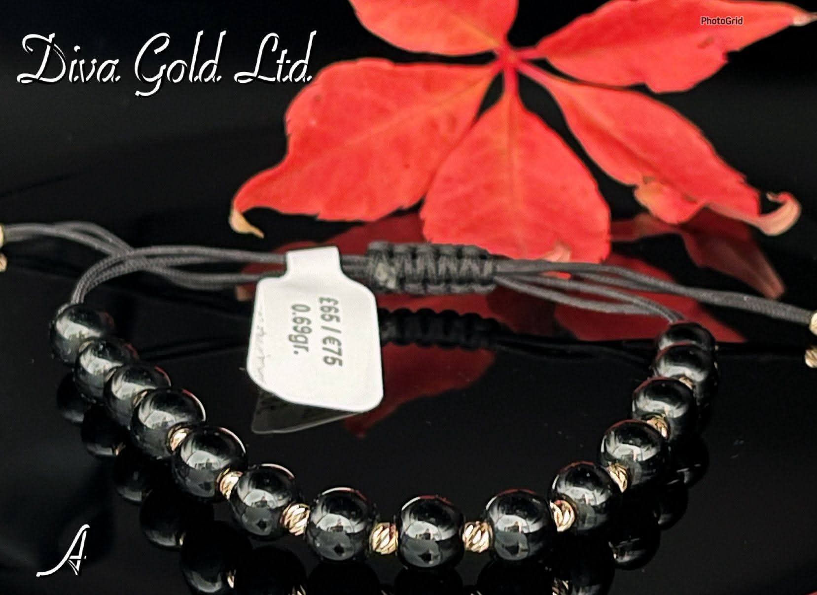 Black thread bracelet with gold details.