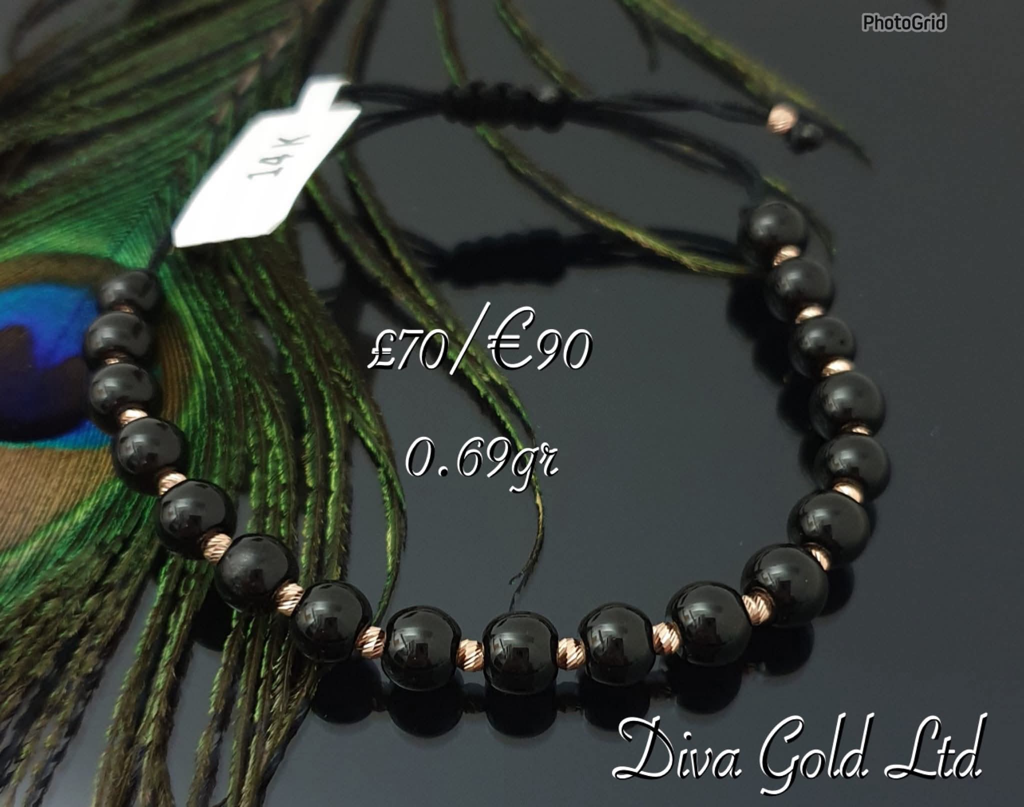 Black thread bracelet with gold details.