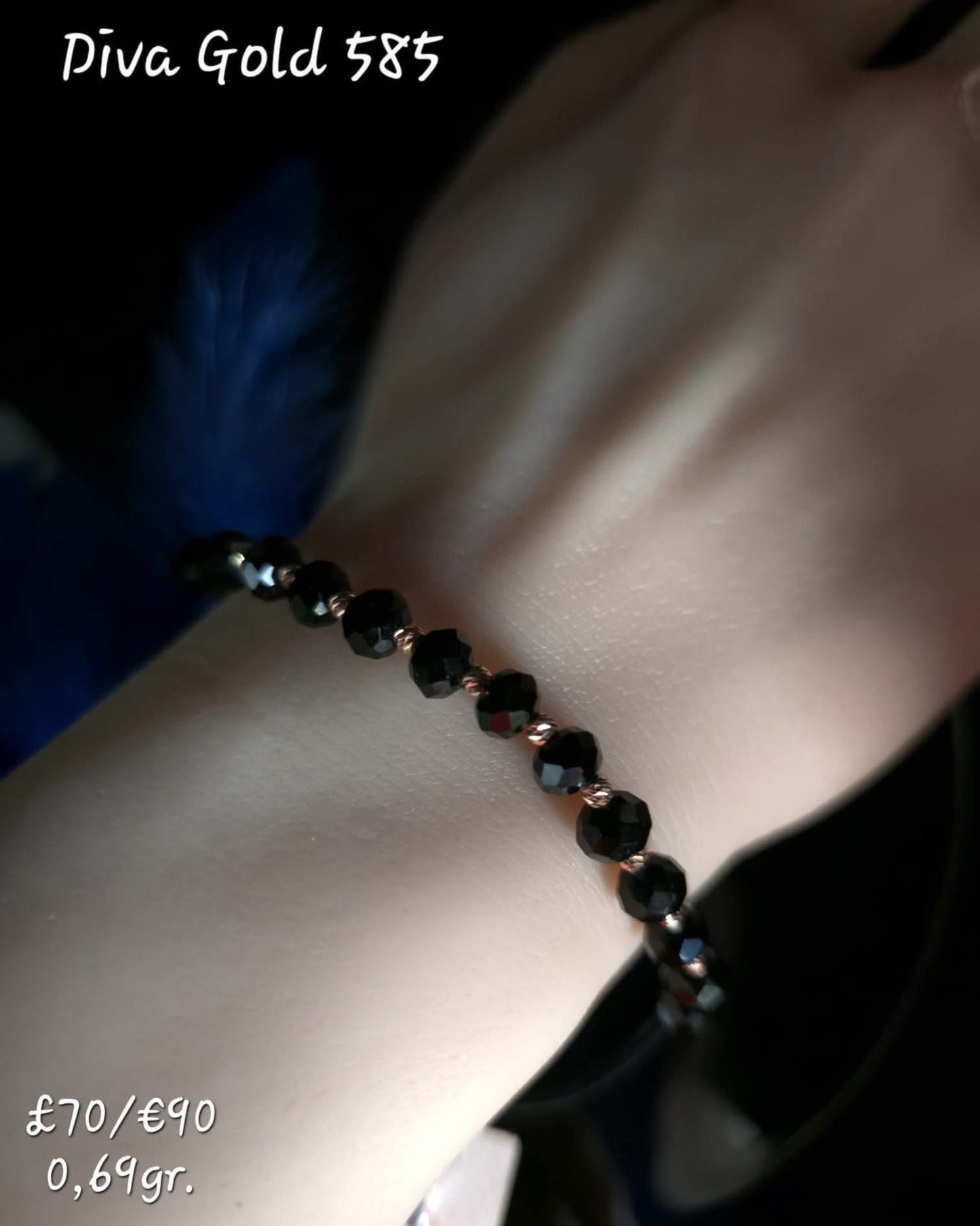 Black thread bracelet with gold details.