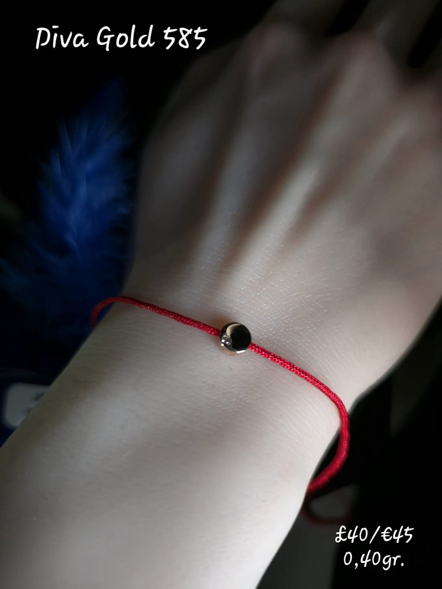 Red thread bracelet with gold details.