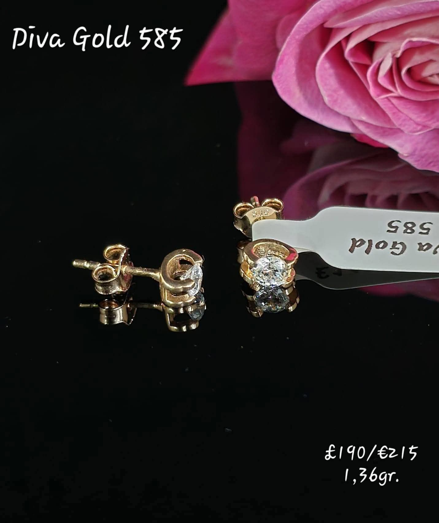Stud gold earrings. White zircon stones