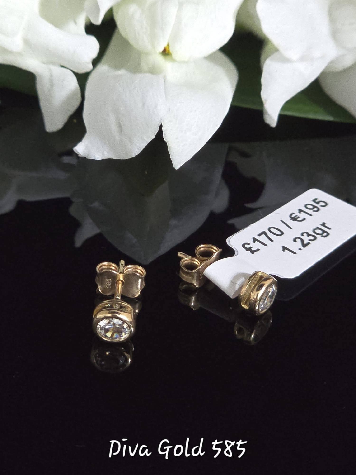 Stud gold earrings. White zircon stones