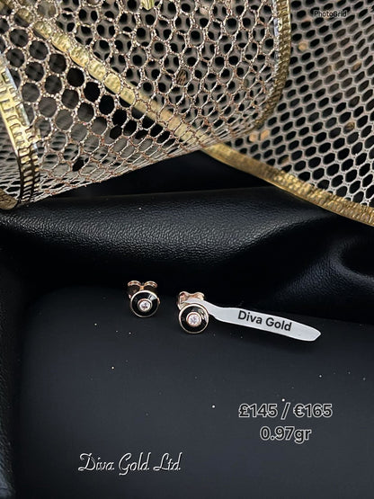 Stud gold earrings.