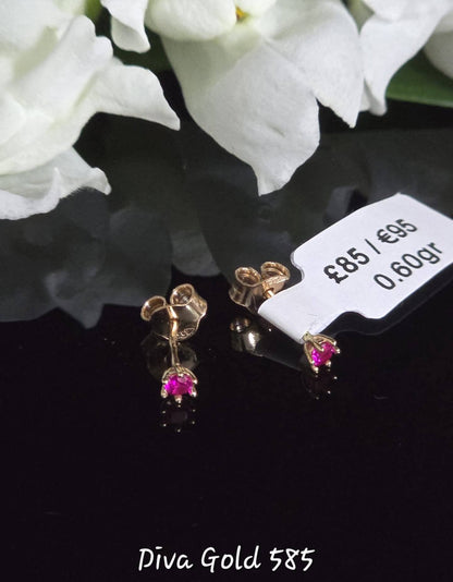 Stud gold earrings with pink zircon stones.