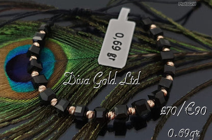 Black thread bracelet with gold details.