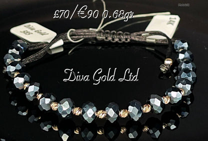 Black thread bracelet with gold details.