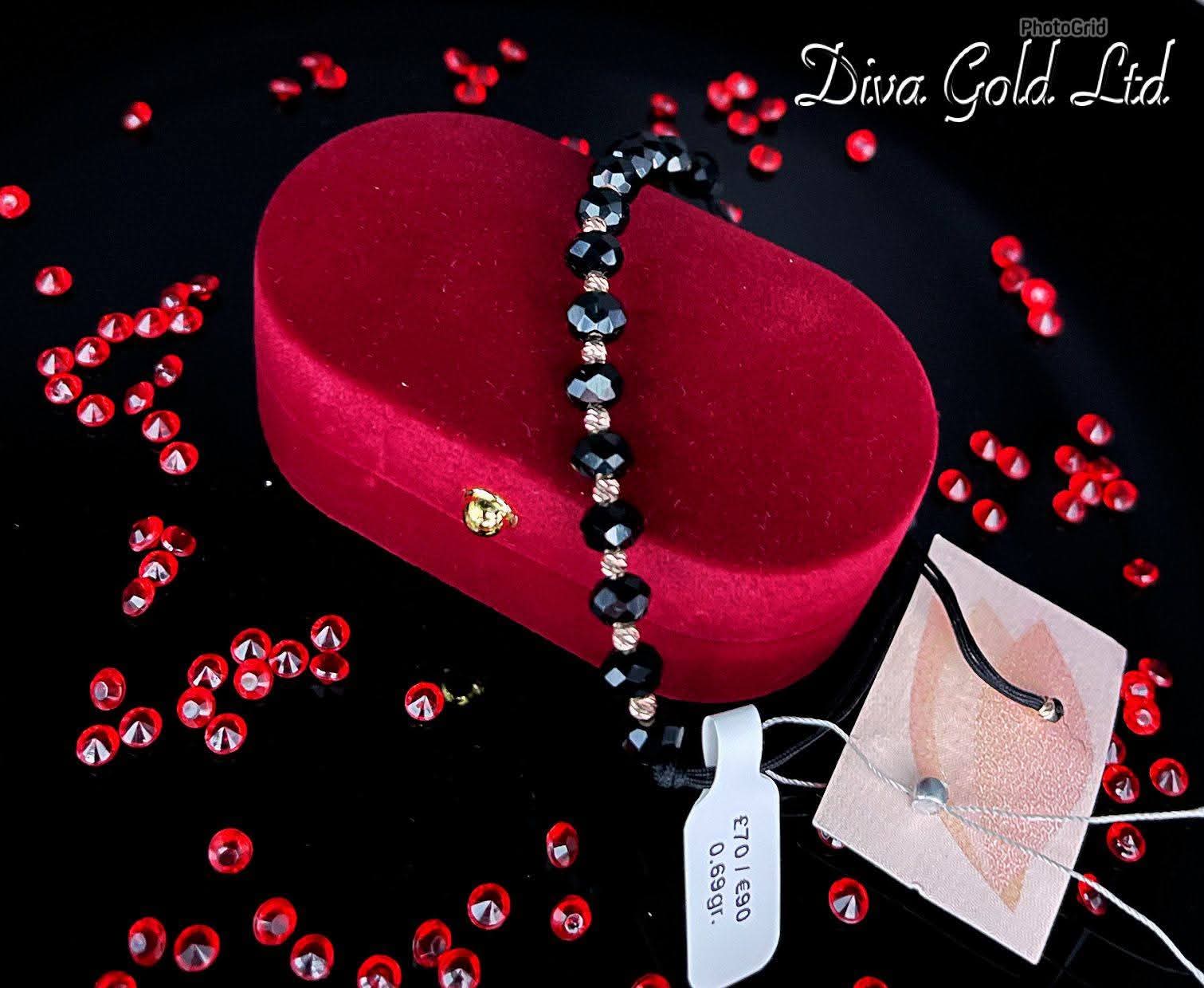 Black thread bracelet with gold details.