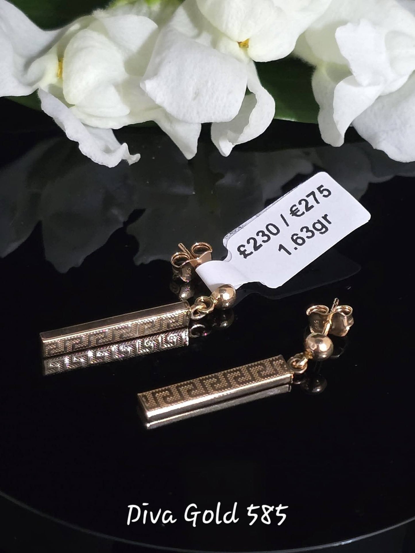 Stud gold earrings.