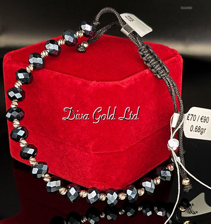 Black thread bracelet with gold details.