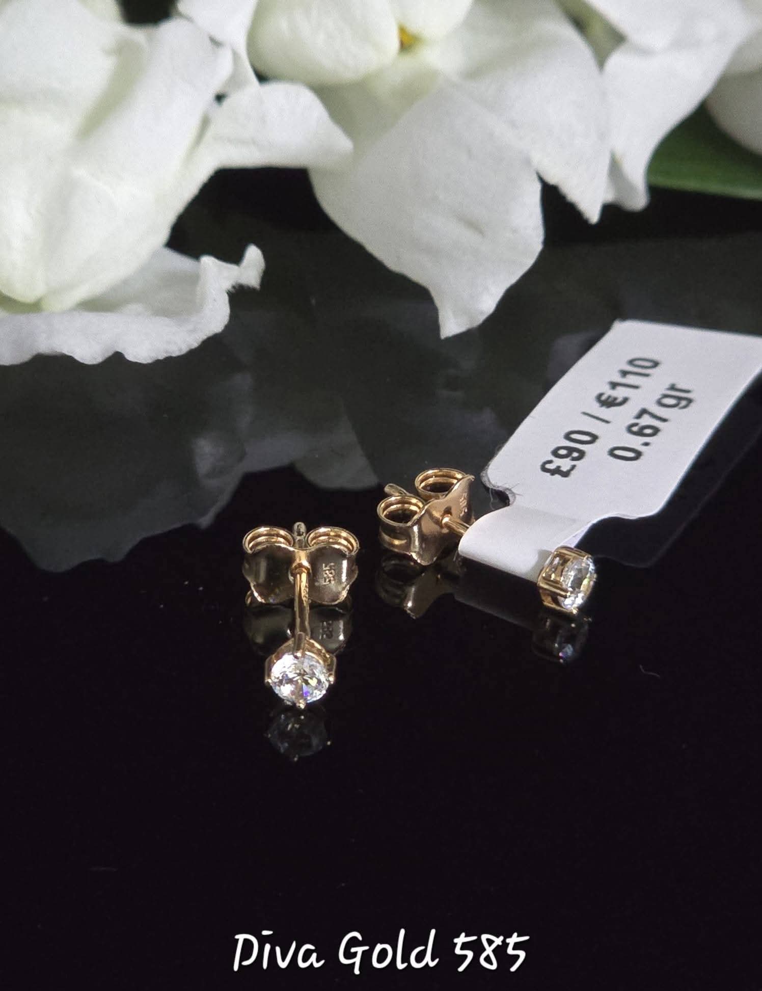 Stud gold earrings white zircon stones.