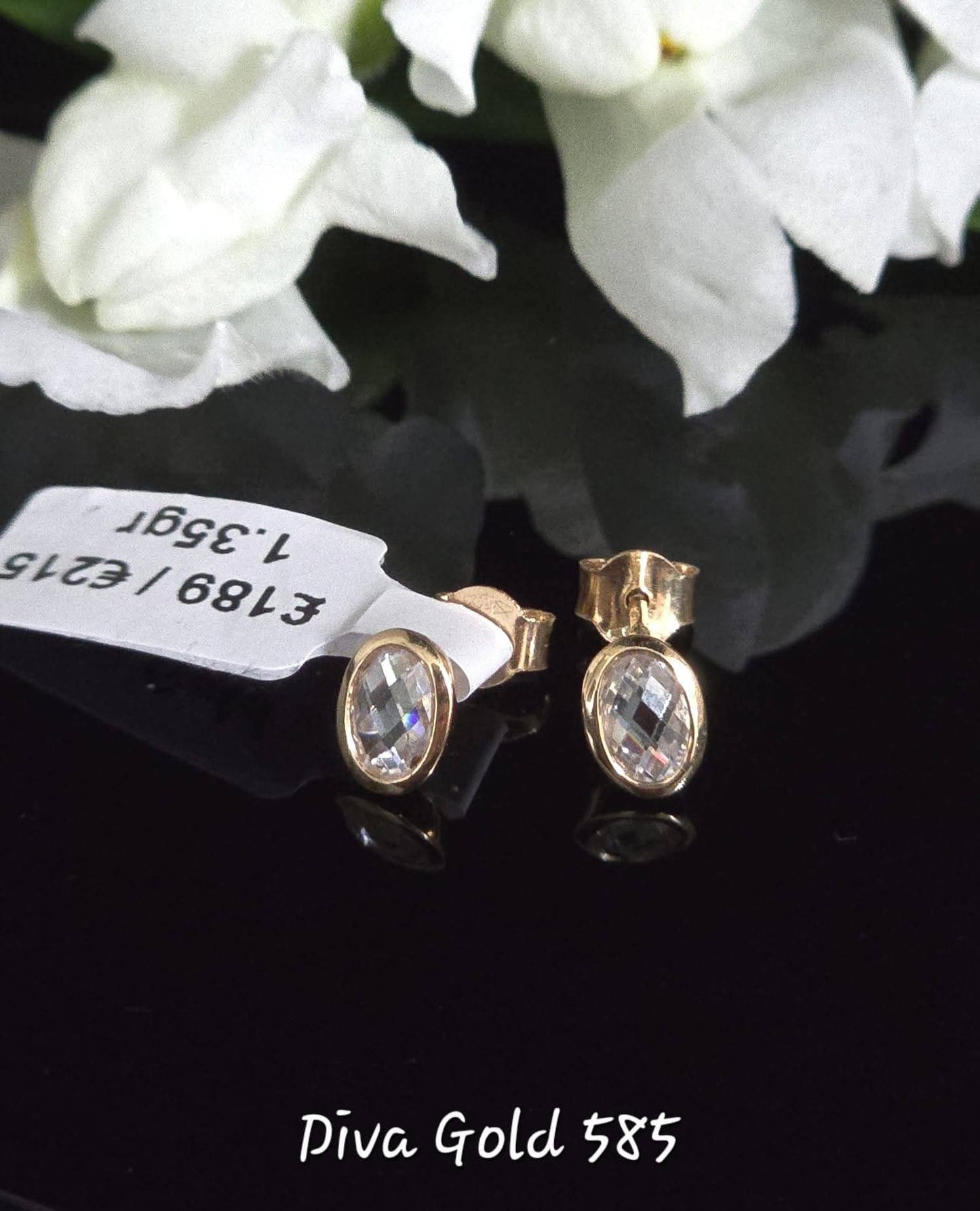 Stud gold earrings.