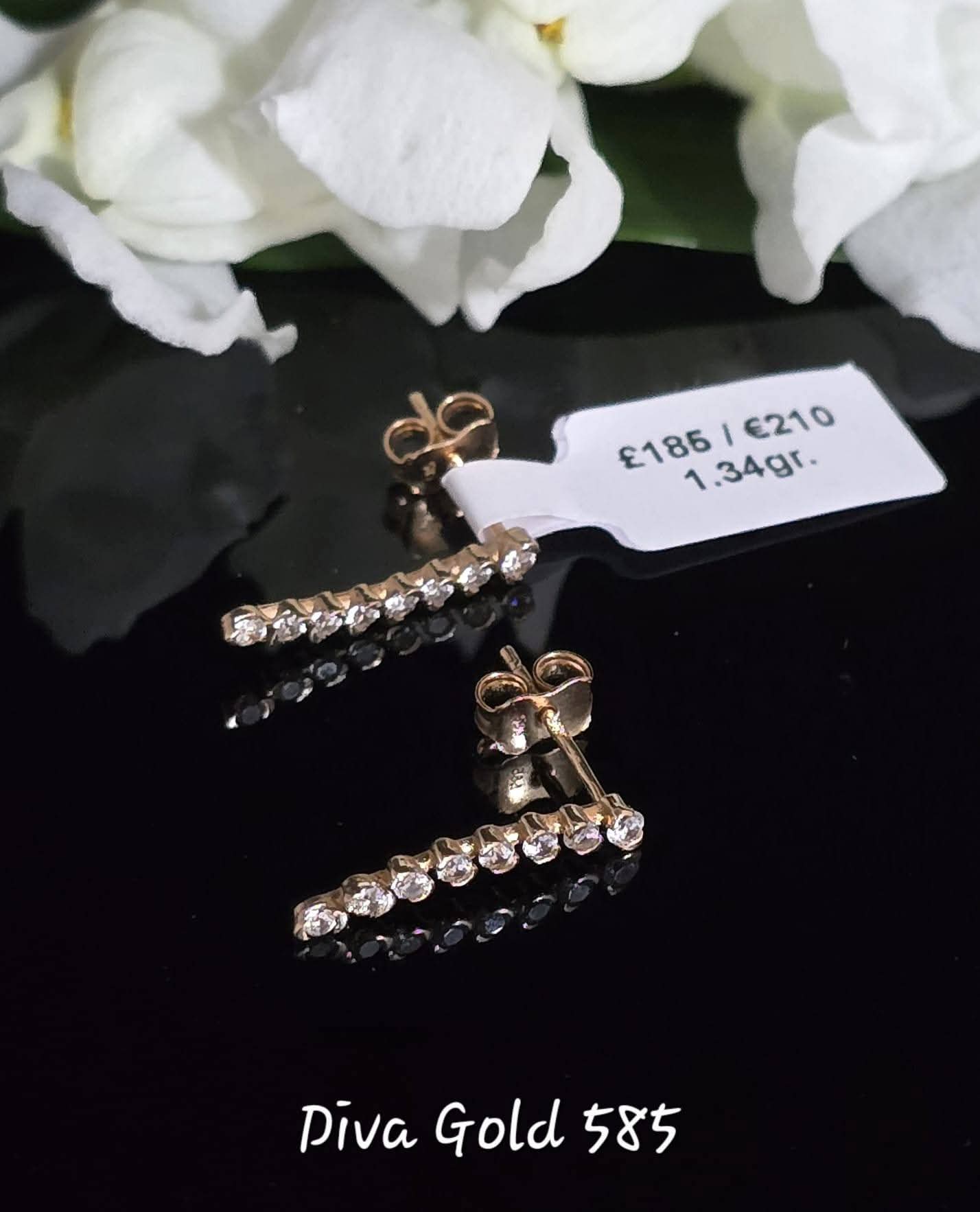 Stud gold earrings with white zircon stones
