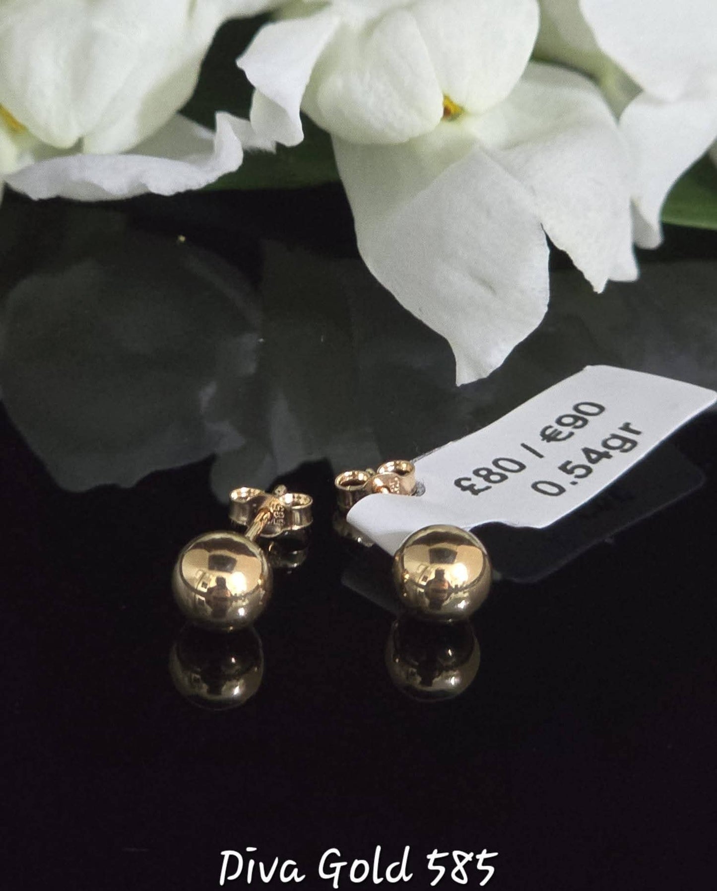 Stud gold earrings.