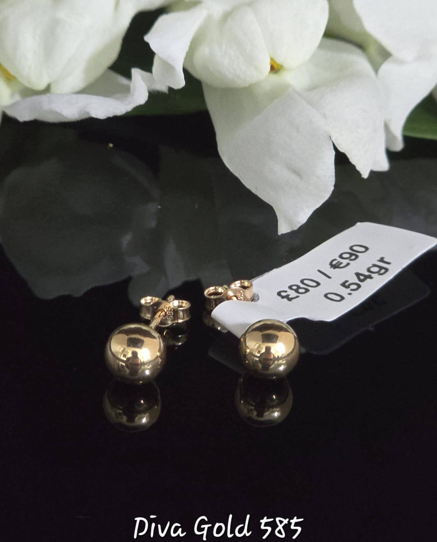 Stud gold earrings.