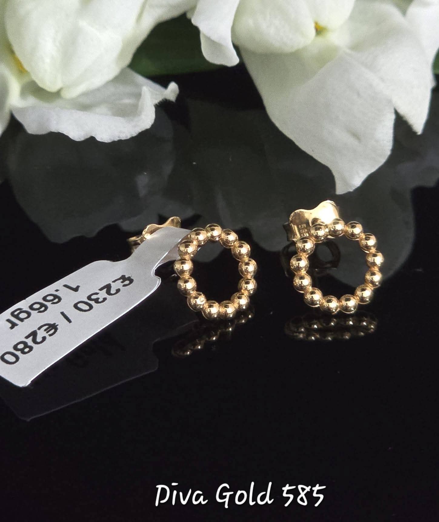 Stud gold earrings.