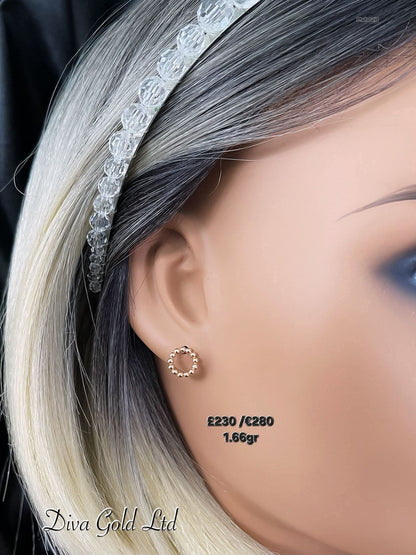 Stud gold earrings.