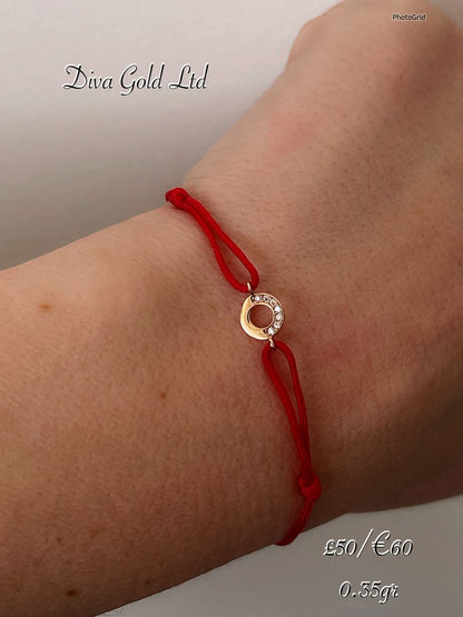 Red thread bracelet with 585 gold details. 0.35gram