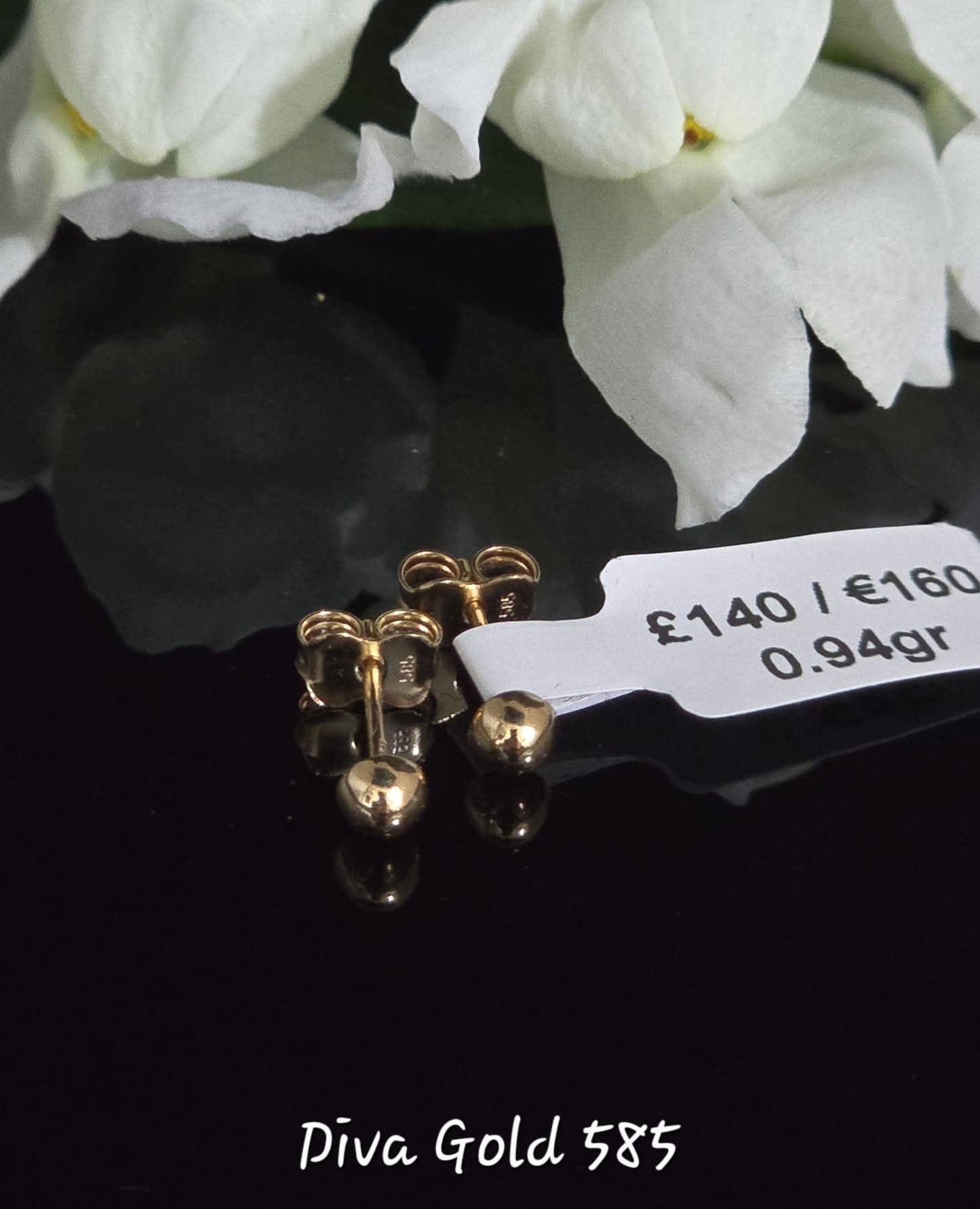 Stud gold earrings.