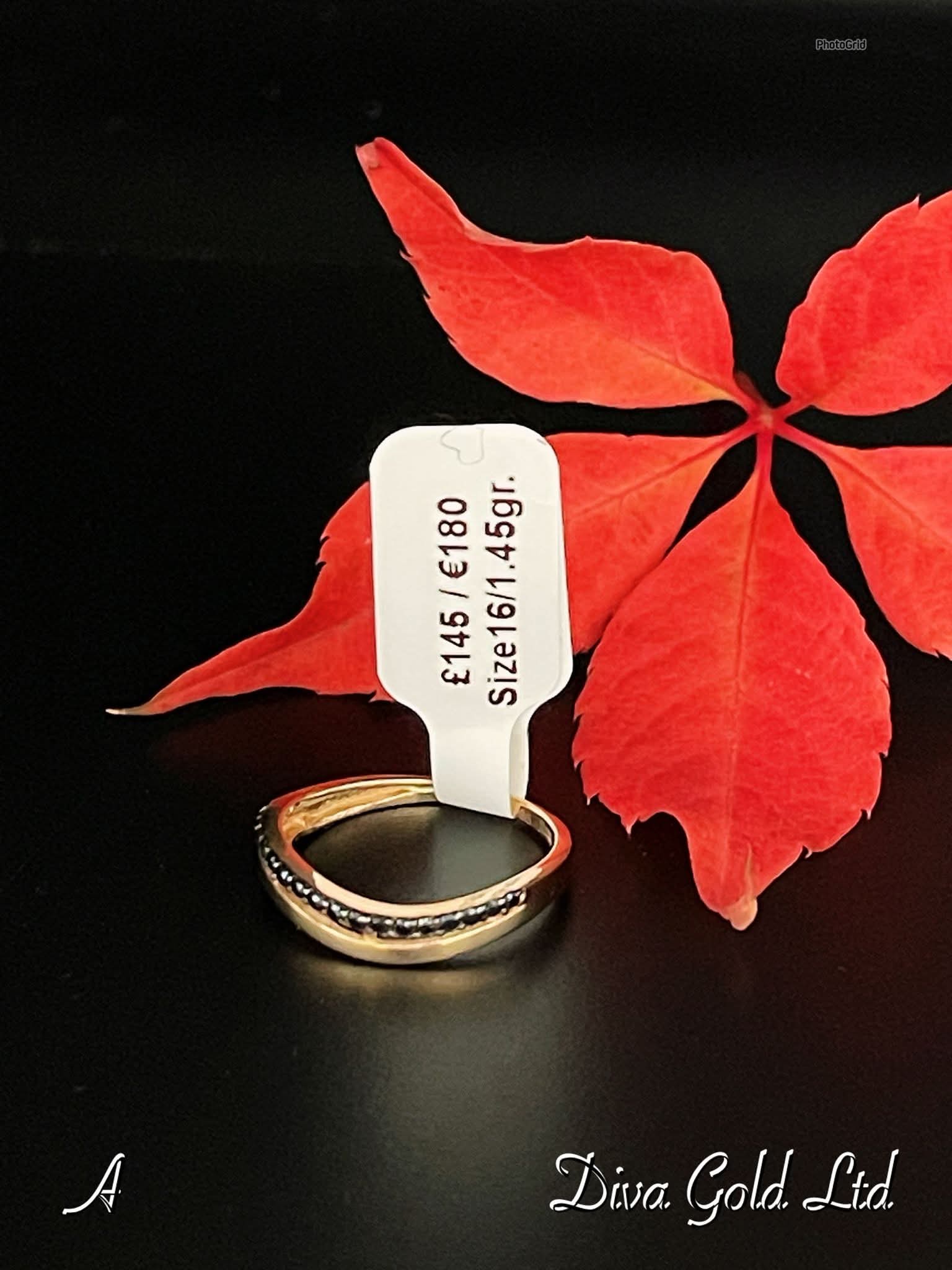 Gold ring with black zircom stones. Size 16