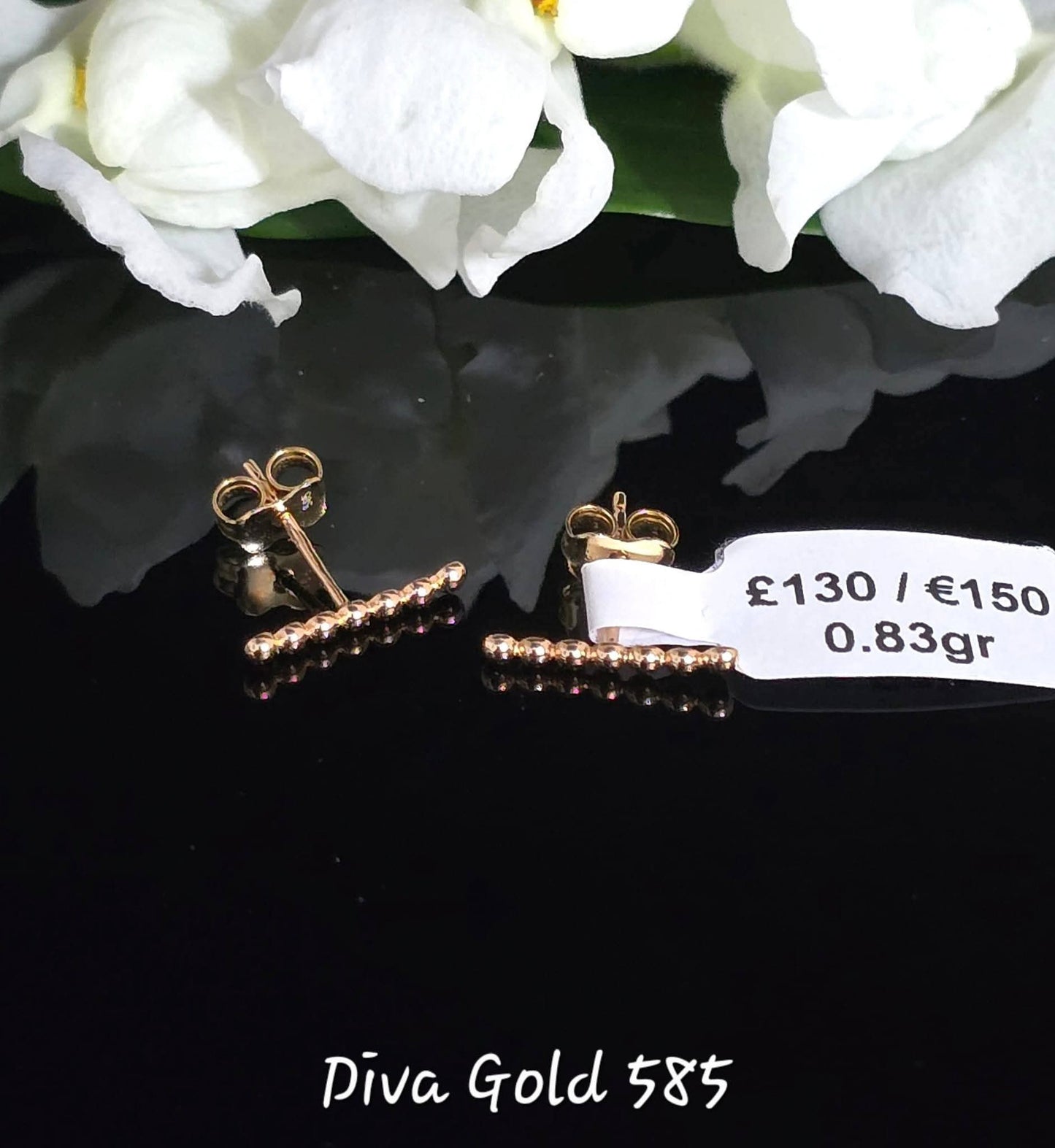 Stud gold earrings.
