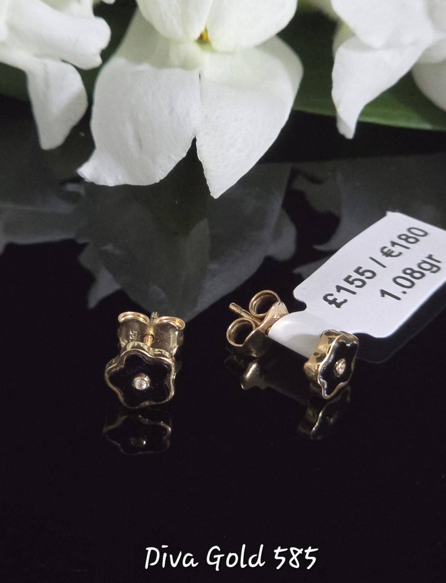 Stud gold earrings.