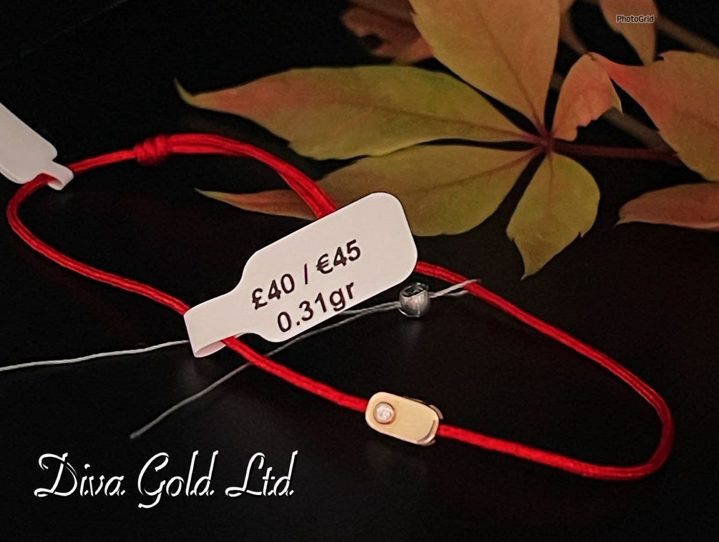 Red thread bracelet with gold details.