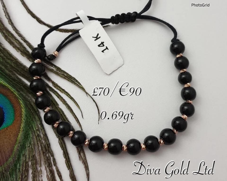 Black thread bracelet with gold details.