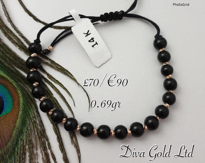 Black thread bracelet with gold details.