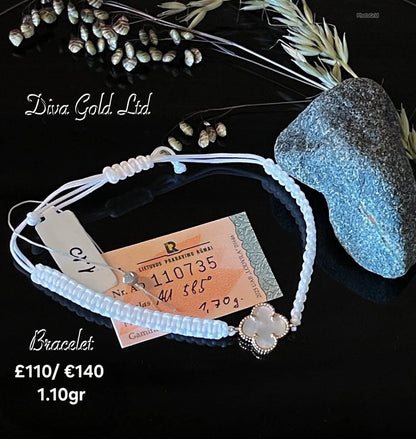 White clover thread bracelet with gold details.
