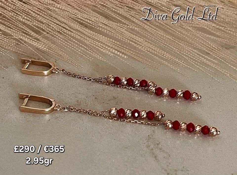 Gold 585 earrings with red zircon stones.