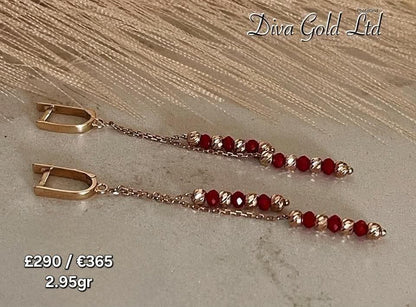 Gold 585 earrings with red zircon stones.