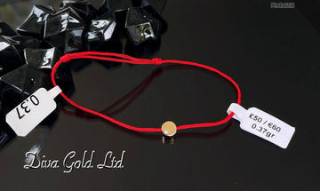 Red thread bracelet with 585 gold details.0.37gram