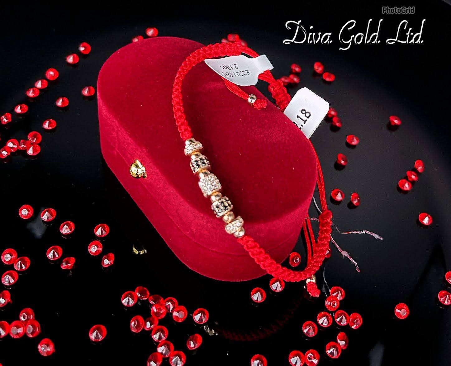 Red thread bracelet with gold details.