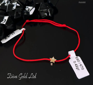 Red thread bracelet with 585 gold details. 0.42gram
