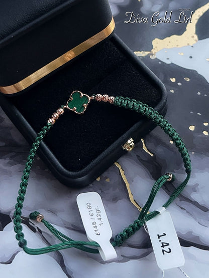 Clover green thread bracelet with gold details.