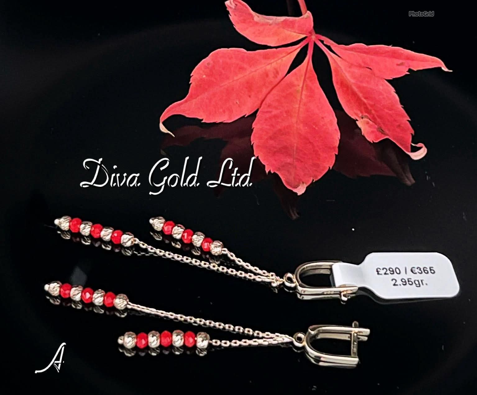 Gold 585 earrings with red zircon stones.