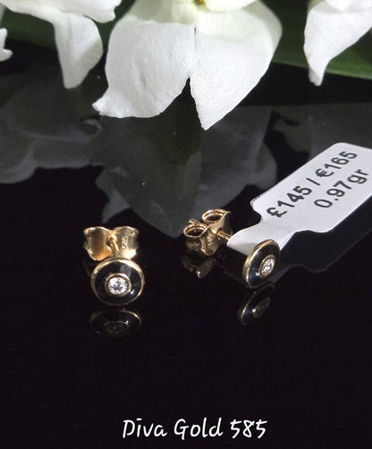 Stud gold earrings.